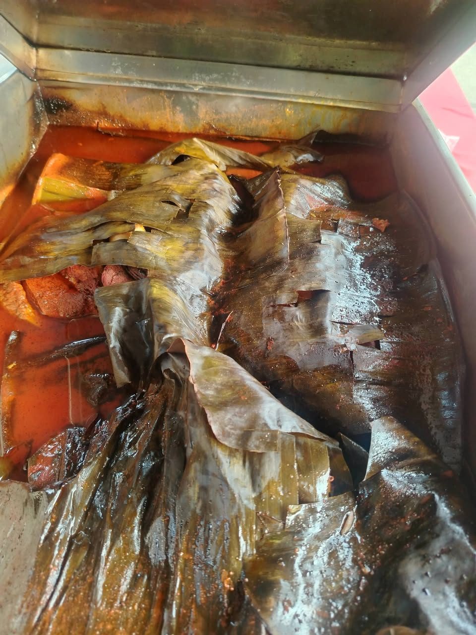 Huachinango (pargo) fresco en una caja roja con hielo, mostrando pescados enteros preparados para venta.